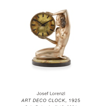 an art deco clock with a Josef Lorenzl statue